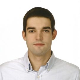 Unsmiling closeup of a man in front of a white background